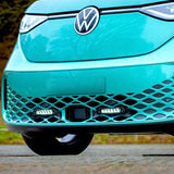 Close-up of a turquoise Volkswagen car with a blurred natural background