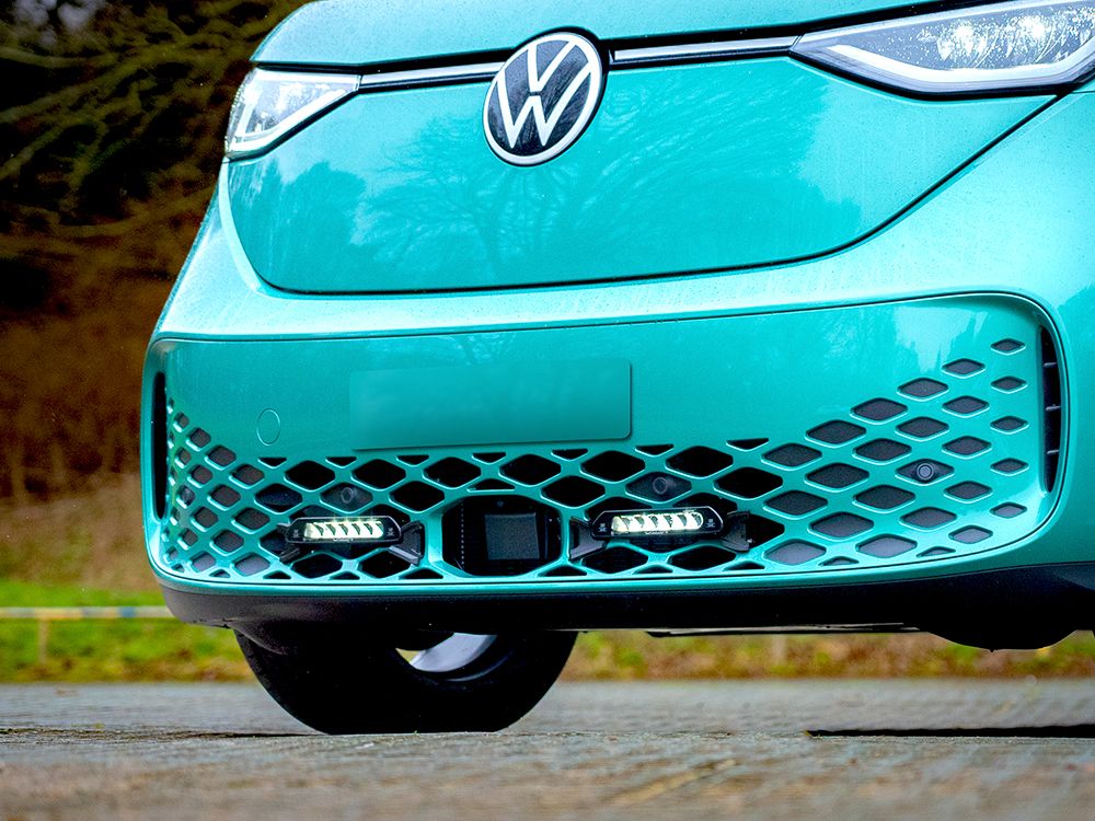 Close-up of a turquoise Volkswagen car with a blurred natural background