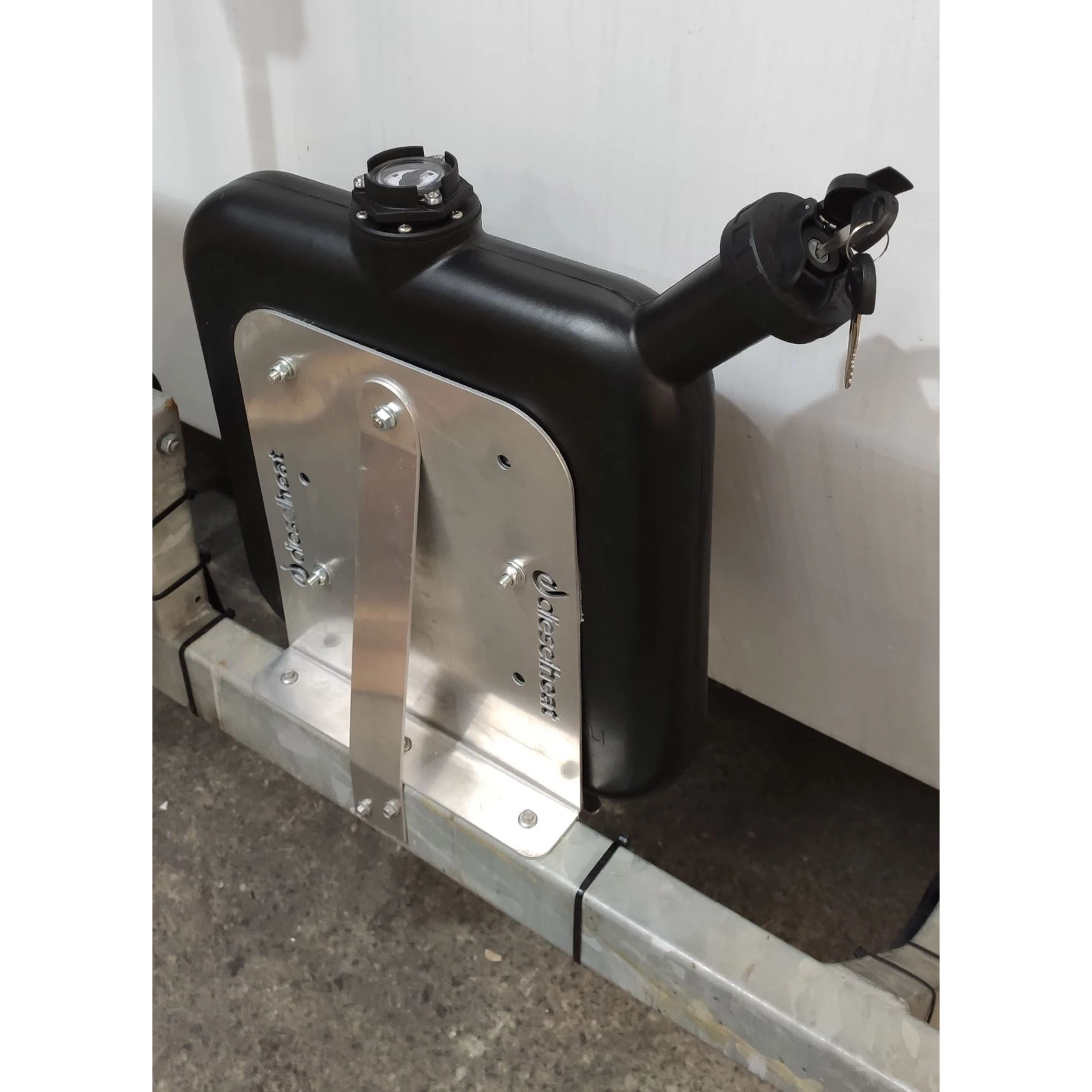 Fuel tank with metal bracket attached to a vehicle frame against a white background – Diesel Heat Wafer Tank Mounting Bracket — 10L Black Fuel Tank