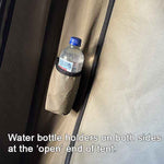 Water bottle holder on a tent with text indicating it's at the 'open' end of the tent.