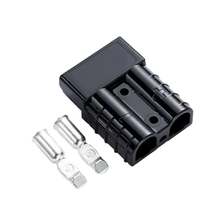 Black Anderson-style 50 amp connector housing at an angle with two silver contacts laid in front, the moulded body showing its two cable cavities and polarity marks