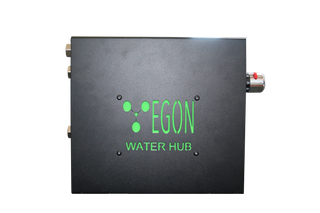 The EGON Water Hub square on to the cover face, showing the green logo, the three plumbing ports down the left edge and the thermostatic mixing valve projecting from the right
