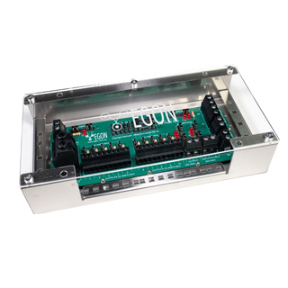The EGON DC Hub fitted in its aluminium bracket with the clear polycarbonate cover screwed down, so the fuse banks, LEDs and screw terminals stay visible while protected